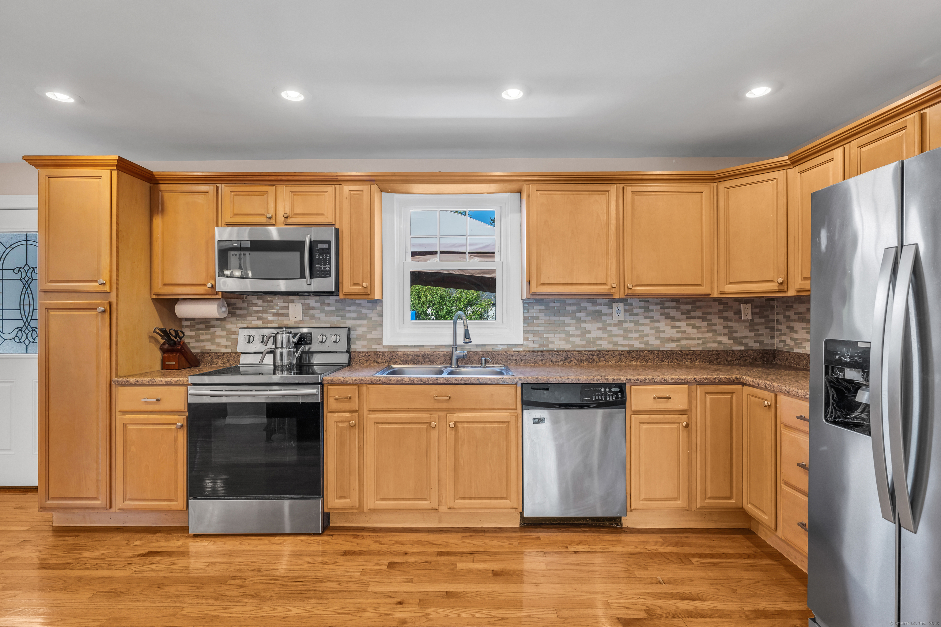 64 Dohm Avenue Guilford, CT 06437 - Photo 9 of 38 a kitchen with stainless steel appliances granite countertop a stove a sink dishwasher a refrigerator and a microwave