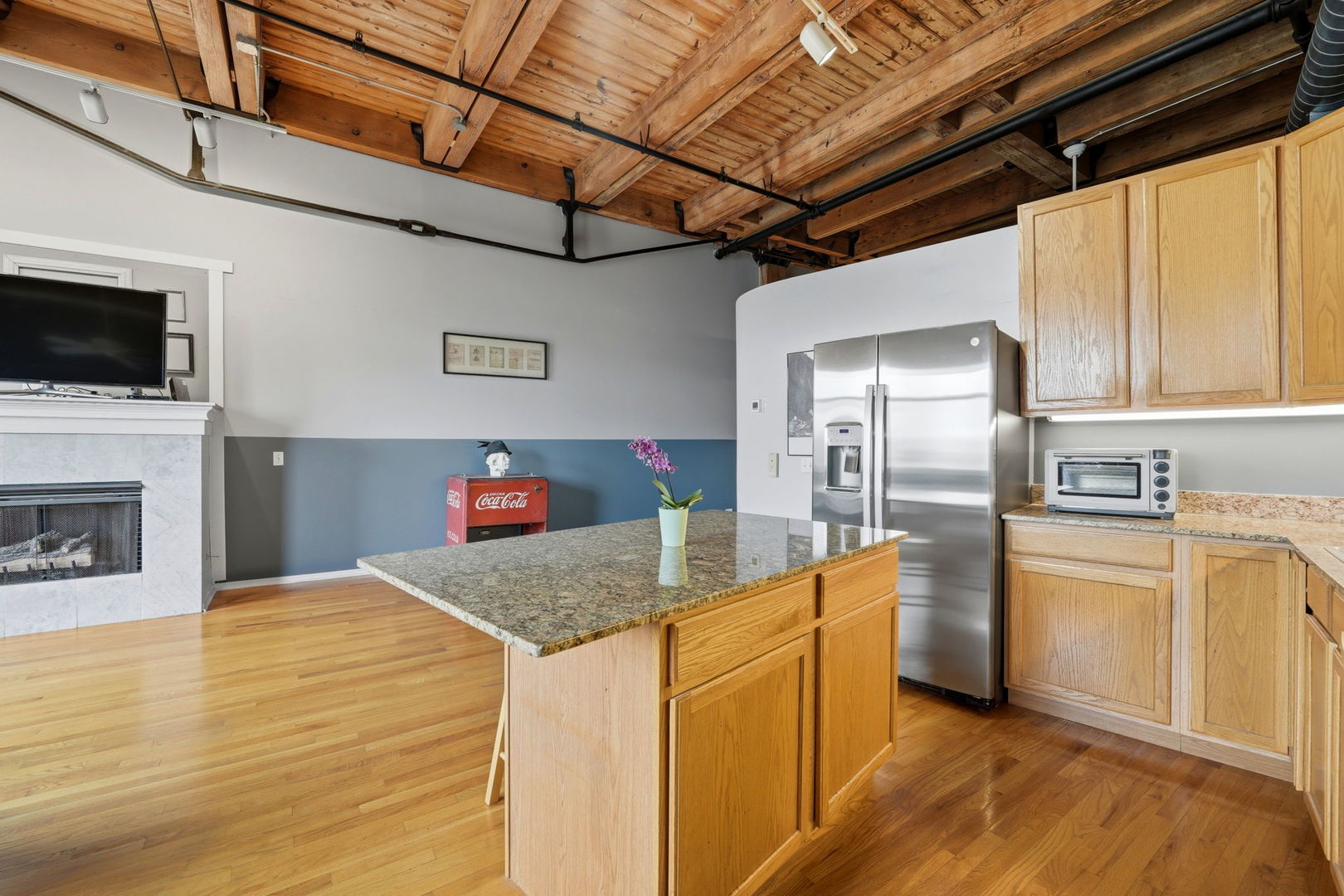 1550 South Indiana Avenue, Unit 401 Chicago, IL 60605 - Photo 5 of 20 a kitchen with stainless steel appliances granite countertop a sink dishwasher a stove and a refrigerator with wooden floor