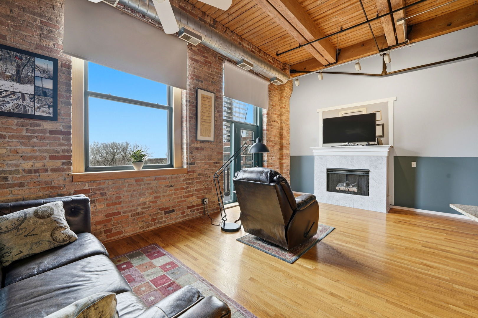 1550 South Indiana Avenue, Unit 401 Chicago, IL 60605 - Photo 6 of 20 a living room with furniture a flat screen tv and a fireplace