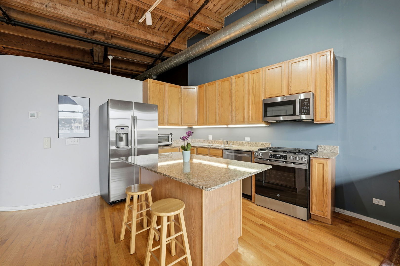 1550 South Indiana Avenue, Unit 401 Chicago, IL 60605 - Photo 8 of 20 a kitchen with stainless steel appliances granite countertop a sink stove and refrigerator