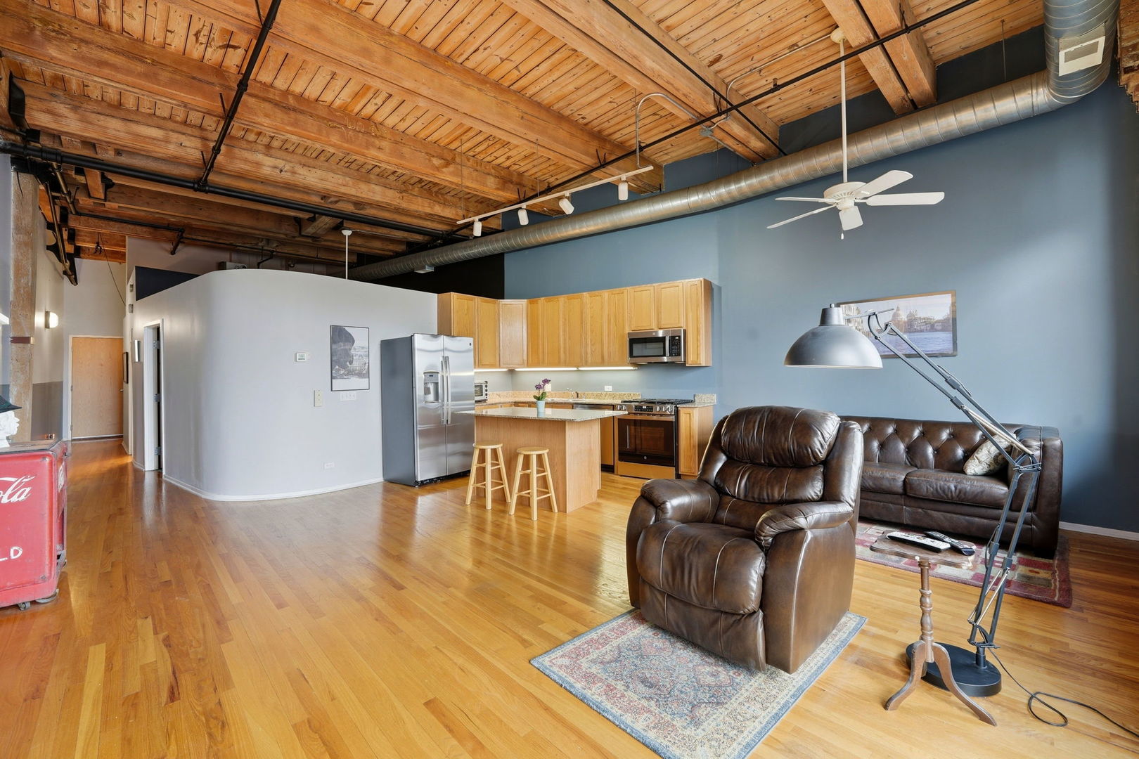 1550 South Indiana Avenue, Unit 401 Chicago, IL 60605 - Photo 9 of 20 a living room with stainless steel appliances kitchen island granite countertop furniture and a wooden floor