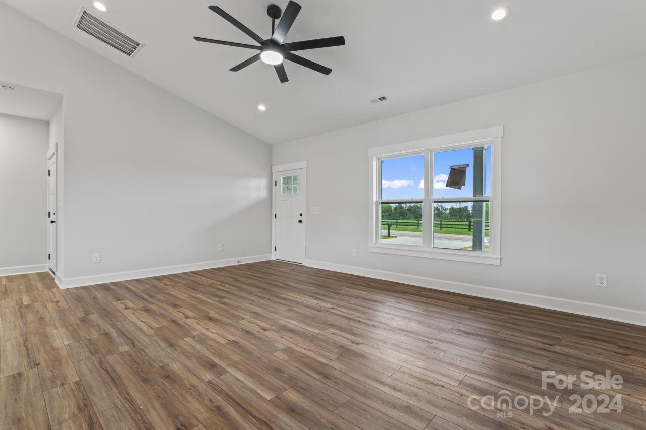234 Briggs Road Salisbury, NC 28147 - Photo 15 of 35 a view of empty room with wooden floor and fan