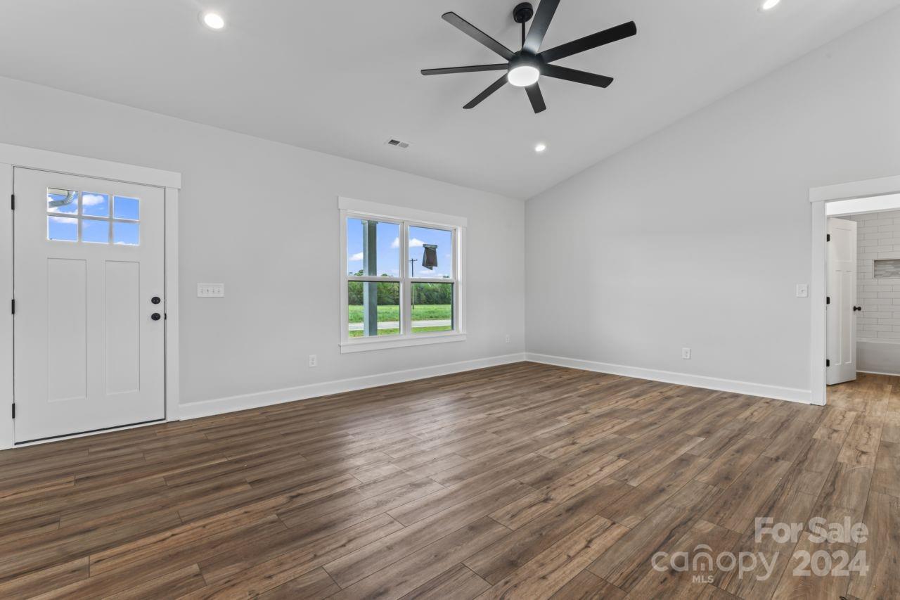 234 Briggs Road Salisbury, NC 28147 - Photo 16 of 35 an empty room with wooden floor fan and windows