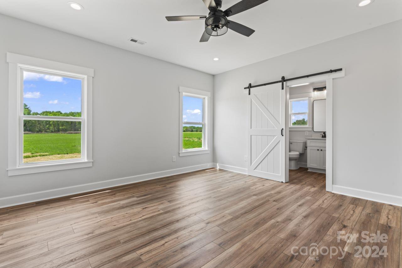 234 Briggs Road Salisbury, NC 28147 - Photo 17 of 35 a view of an empty room with a window and wooden floor
