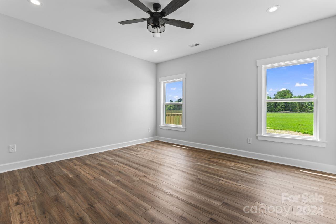 234 Briggs Road Salisbury, NC 28147 - Photo 20 of 35 a view of an empty room with a window and wooden floor