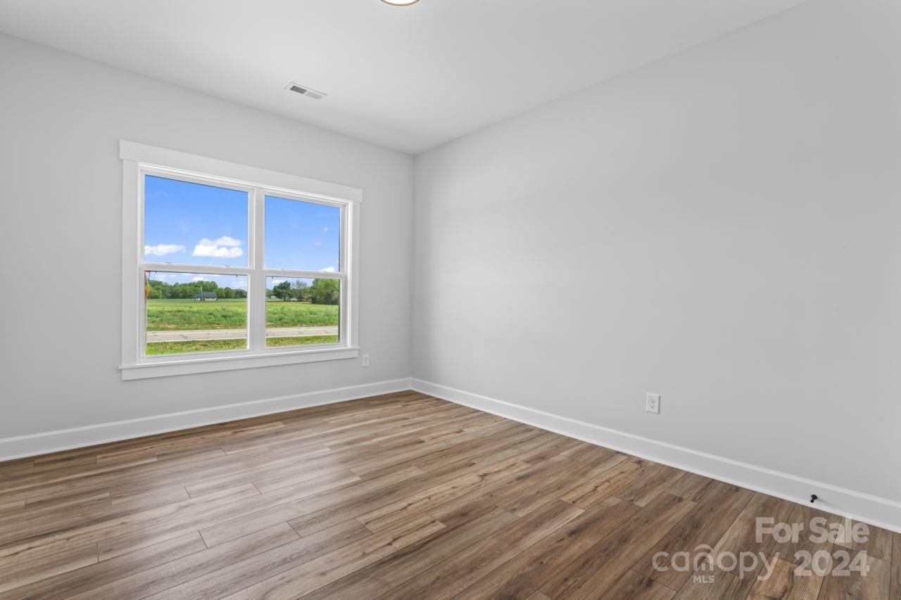 234 Briggs Road Salisbury, NC 28147 - Photo 24 of 35 a view of an empty room with wooden floor and a window