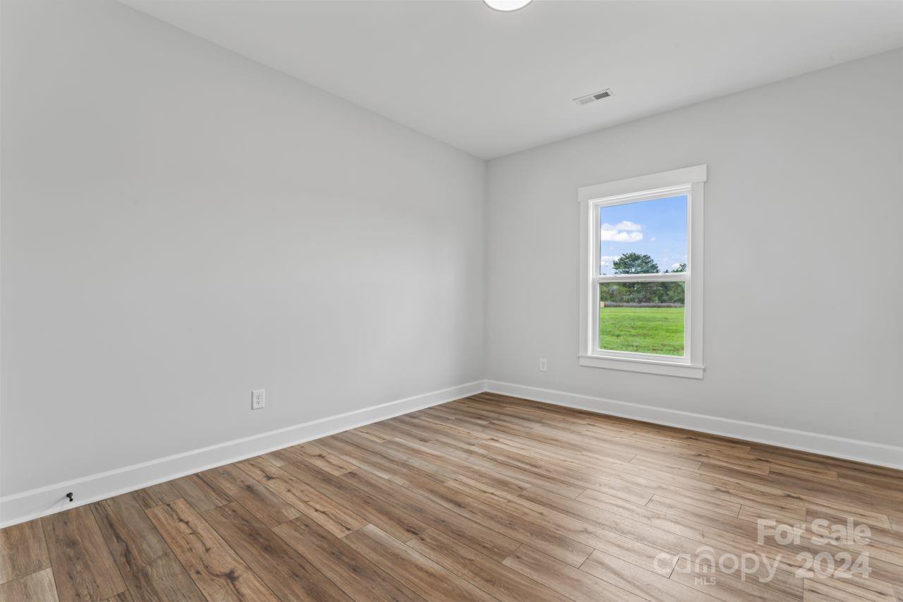 234 Briggs Road Salisbury, NC 28147 - Photo 28 of 35 an empty room with wooden floor and windows
