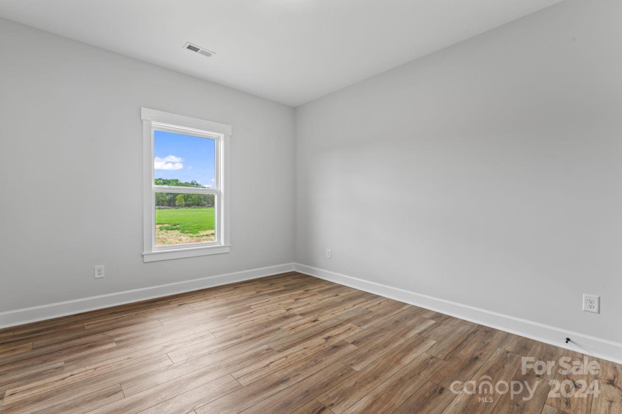 234 Briggs Road Salisbury, NC 28147 - Photo 30 of 35 a view of an empty room with wooden floor and a window