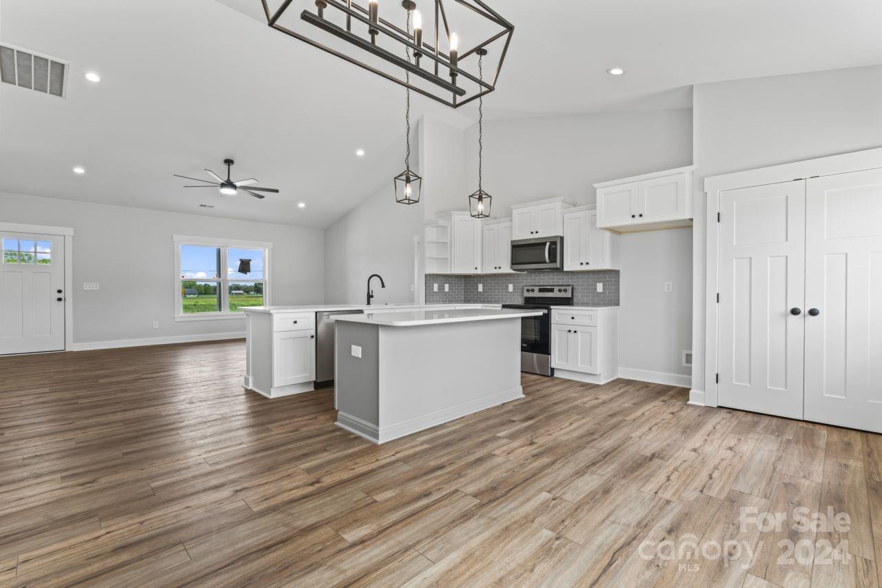 234 Briggs Road Salisbury, NC 28147 - Photo 8 of 35 a view of kitchen with wooden floor and electronic appliances