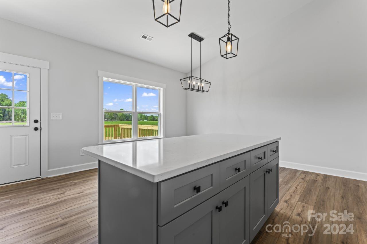 234 Briggs Road Salisbury, NC 28147 - Photo 9 of 35 a room with a table a chandelier and wooden floor
