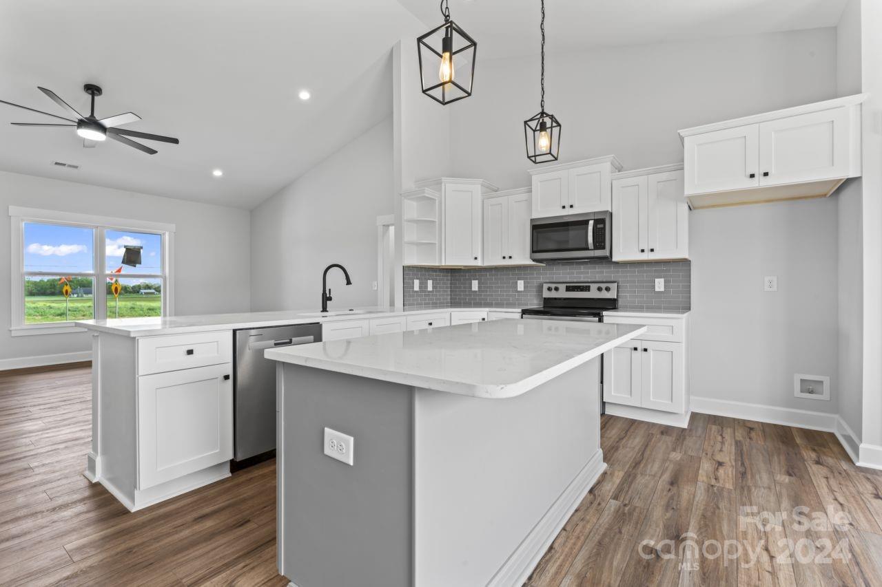 234 Briggs Road Salisbury, NC 28147 - Photo 10 of 35 a kitchen with a sink window and stainless steel appliances