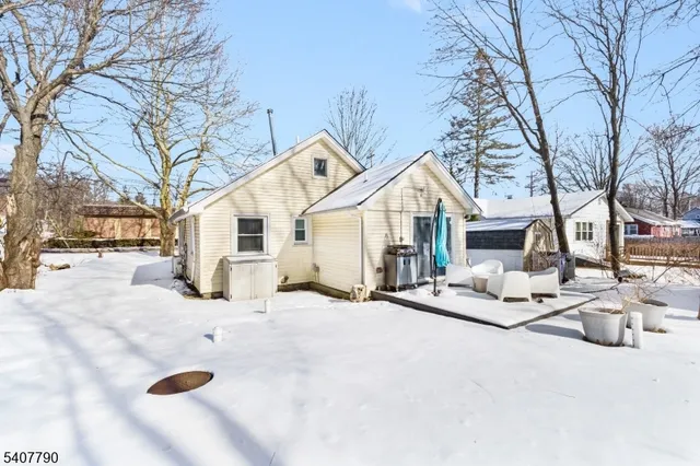 a view of a house with snow on the road