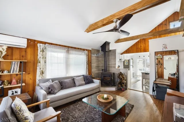a living room with furniture a rug and a large window