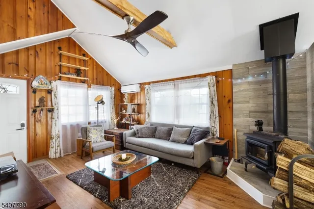 a living room with furniture a rug and a floor to ceiling window