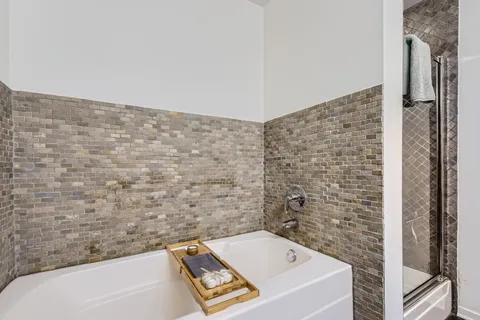 a bathroom with a bathtub and shower