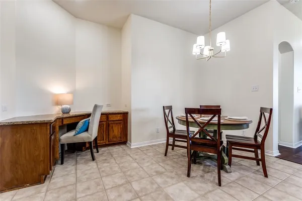 a view of a dining room with furniture and chandelier