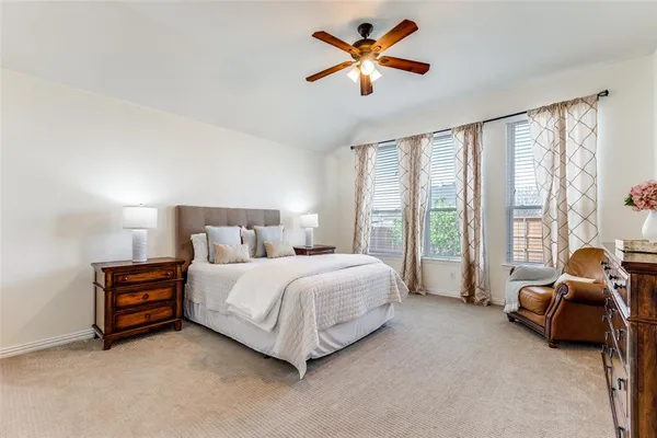 a spacious bedroom with a bed and a large window