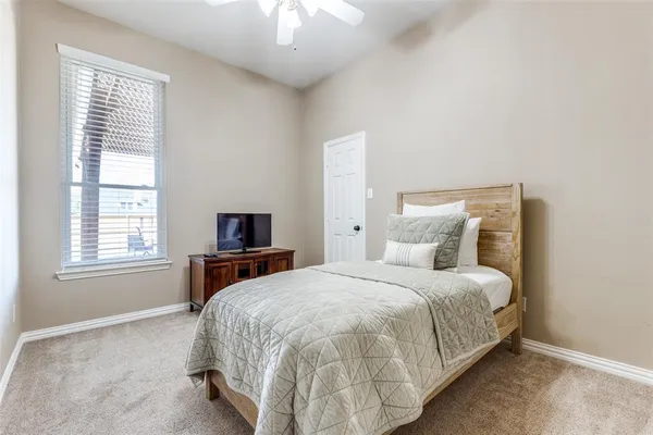 a bedroom with a bed and a tv