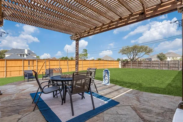 a view of a patio with a table & chairs