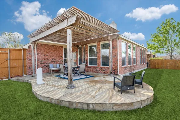 a view of a house with backyard porch and sitting area