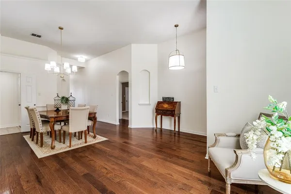a view of a dining room with furniture and wooden floor