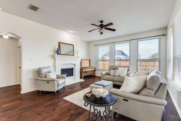 a living room with furniture fireplace and a large window