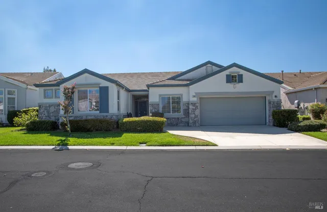 a front view of a house with a yard and garage