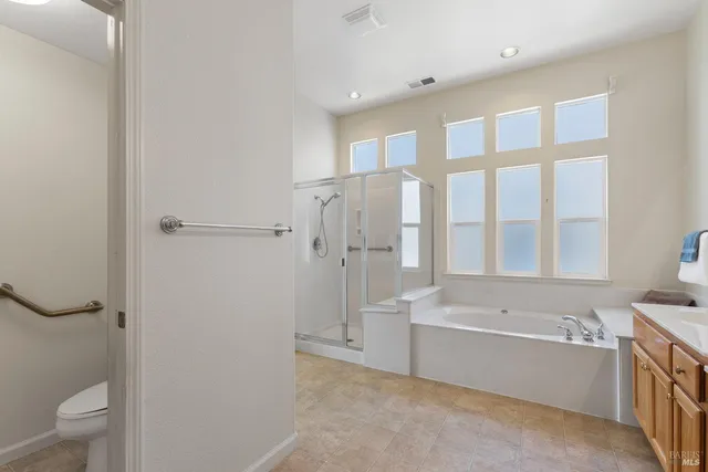 an empty room with a walk in closet and window