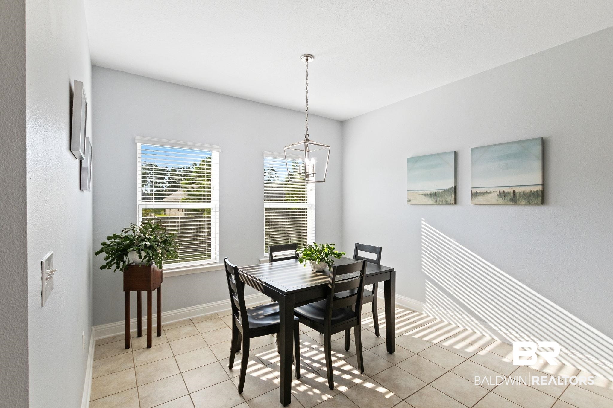 31541 Hoot Owl Road Daphne, AL 36527 - Photo 20 of 51 Tiled dining area featuring an inviting chandelier