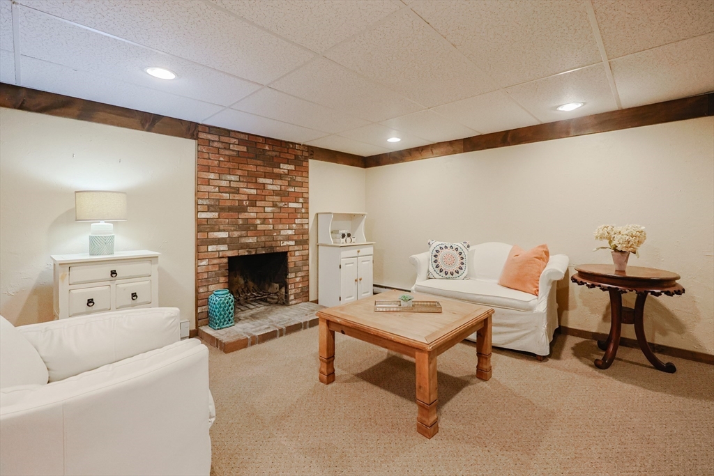77 Dodge Road Sutton, MA 01590 - Photo 25 of 41 a living room with furniture and a fireplace