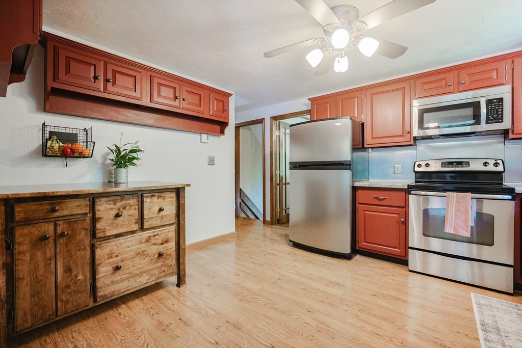 77 Dodge Road Sutton, MA 01590 - Photo 4 of 41 a kitchen with stainless steel appliances granite countertop a refrigerator a stove a sink and dishwasher with wooden floor
