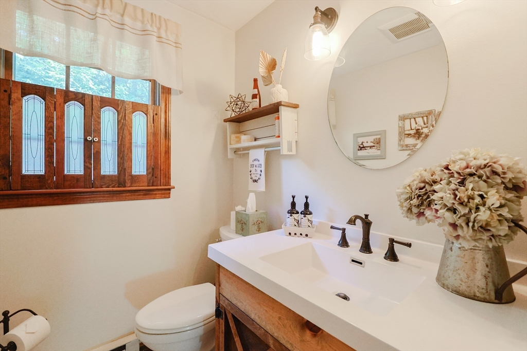 77 Dodge Road Sutton, MA 01590 - Photo 7 of 41 a bathroom with a sink a toilet and mirror