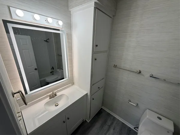a bathroom with a shower and a sink