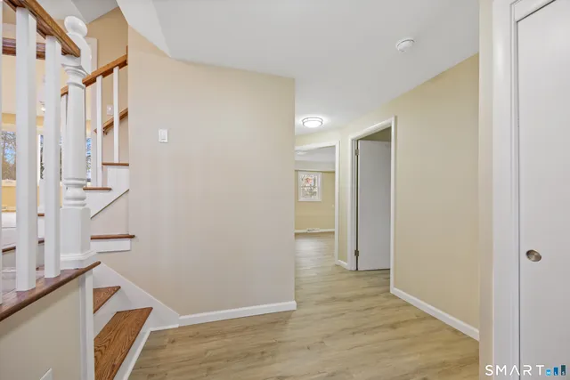 a view of an entryway with wooden floor