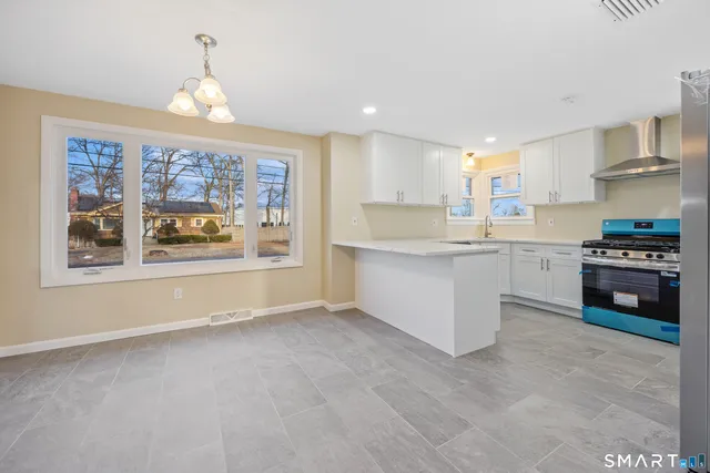 a kitchen with stainless steel appliances granite countertop a stove and a refrigerator