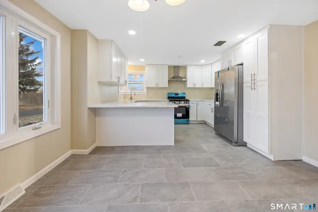 a kitchen with refrigerator and cabinets