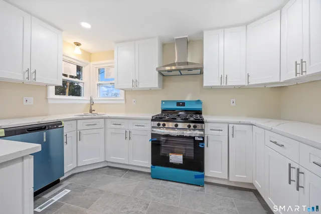 a kitchen with cabinets appliances and a counter space