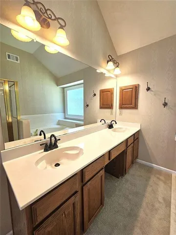 a bathroom with a sink double vanity granite and a mirror