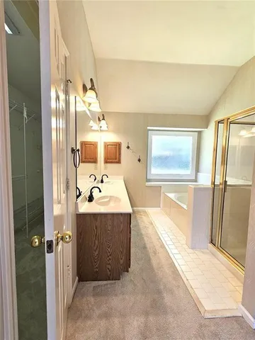 a view of a bathroom with a tub and shower
