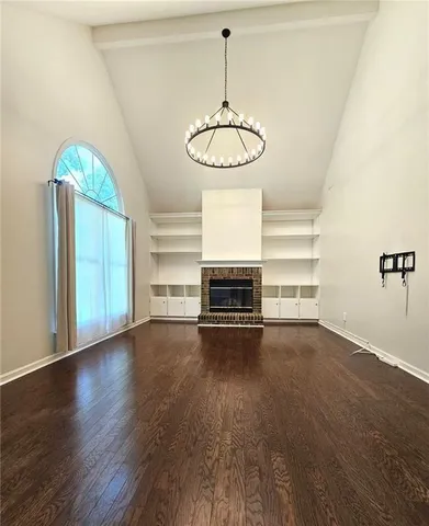 a view of a room with wooden floor window and fireplace