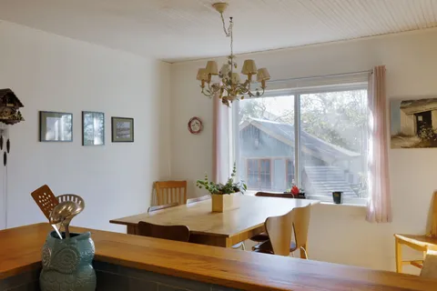 a view of a dining room with furniture a chandelier and wooden floor