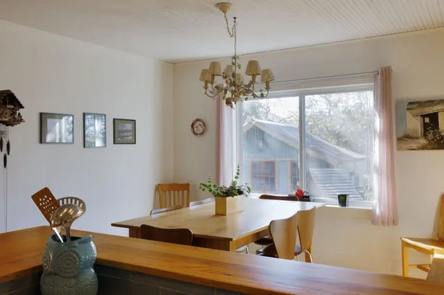 a view of a dining room with furniture a chandelier and wooden floor