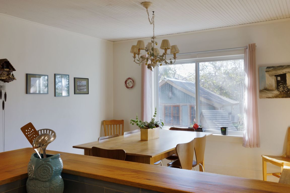 2102 Travis Heights Boulevard Austin, TX 78704 - Photo 11 of 28 a view of a dining room with furniture a chandelier and wooden floor