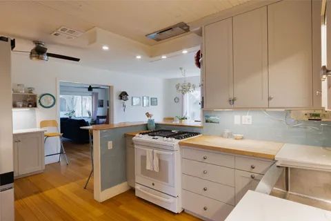 a kitchen with a stove a sink and a refrigerator
