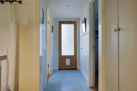a view of a hallway with wooden floor