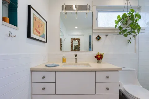 a bathroom with a sink a vanity and a mirror