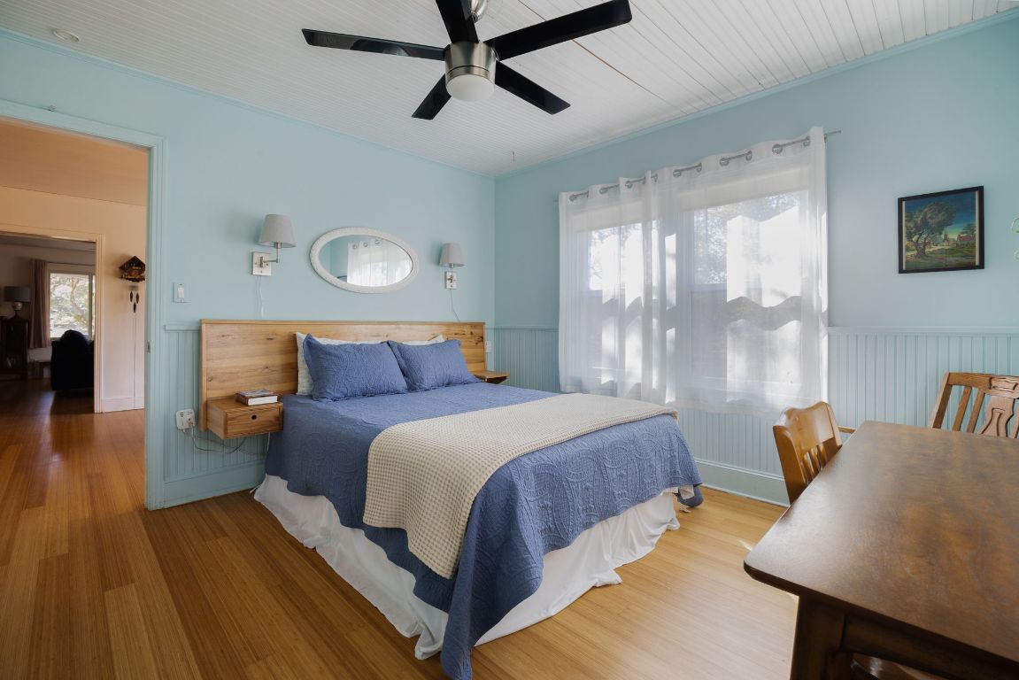 2102 Travis Heights Boulevard Austin, TX 78704 - Photo 21 of 28 a bedroom with a bed and wooden floor