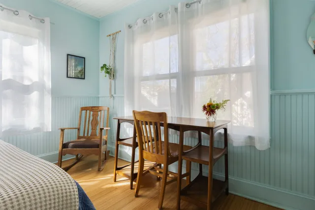 a dining room with furniture and window