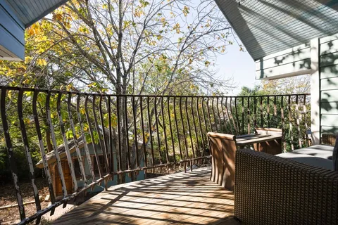 a view of balcony with wooden floor and outdoor seating