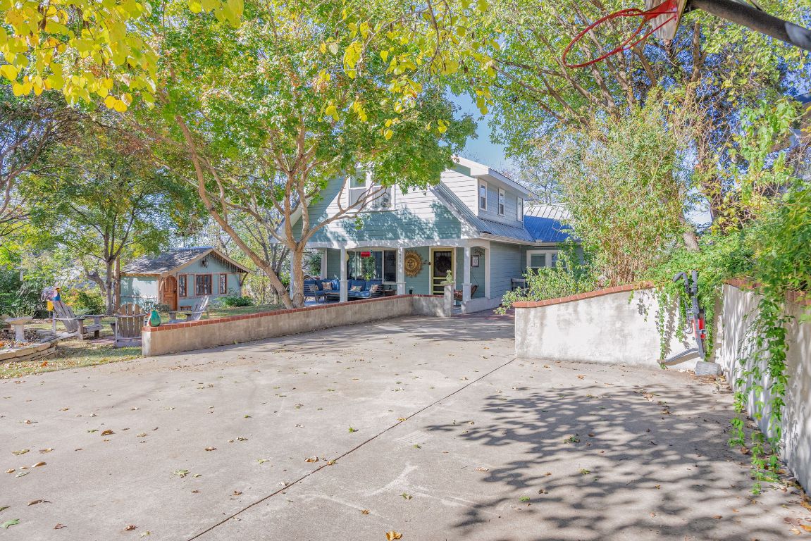 2102 Travis Heights Boulevard Austin, TX 78704 - Photo 3 of 28 a view of a white house with a yard and large tree
